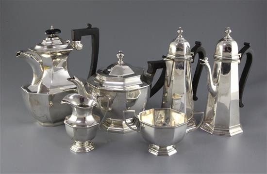 A George V matched four piece octagonal silver tea set and a cafe au lait pair, gross 89.5 oz.